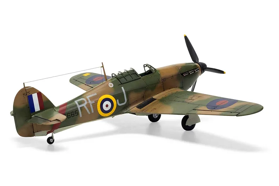 A completed 1/48 scale plastic model of a Hawker Hurricane Mk.1 fighter aircraft, painted in camouflage with RAF markings, viewed from the rear three-quarter angle.