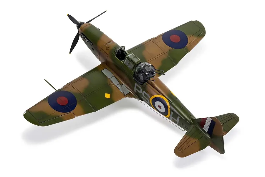 A high-angle studio shot of a completed 1/48 scale Boulton Paul Defiant model aircraft painted in a green and brown camouflage scheme.