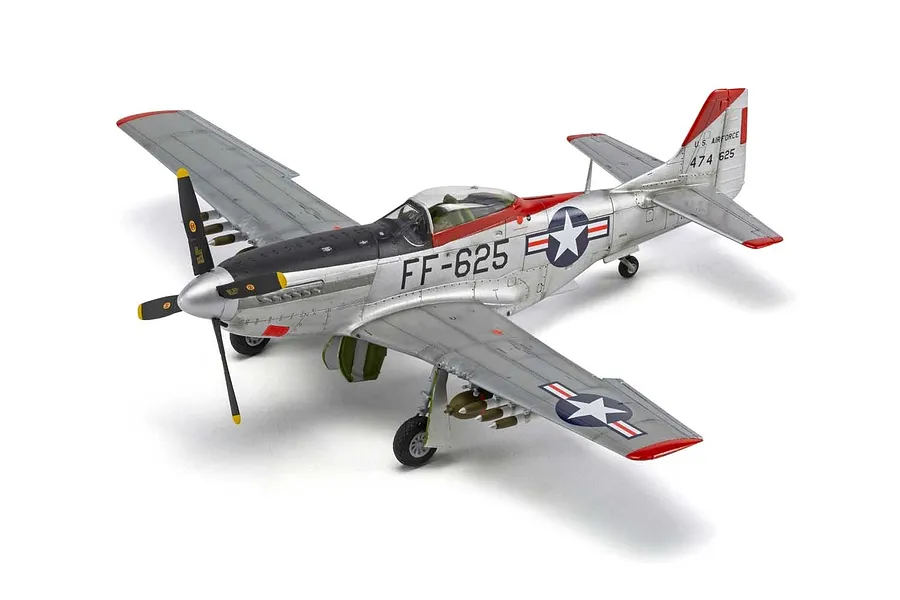 A high-angle studio shot of a fully assembled and painted 1/48 scale North American F-51D Mustang model aircraft on a white background.