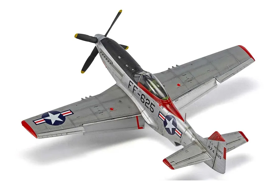 A high-angle studio shot of a completed 1/48 scale Airfix North American F-51D Mustang model aircraft, featuring a silver finish with red wingtips and tail.