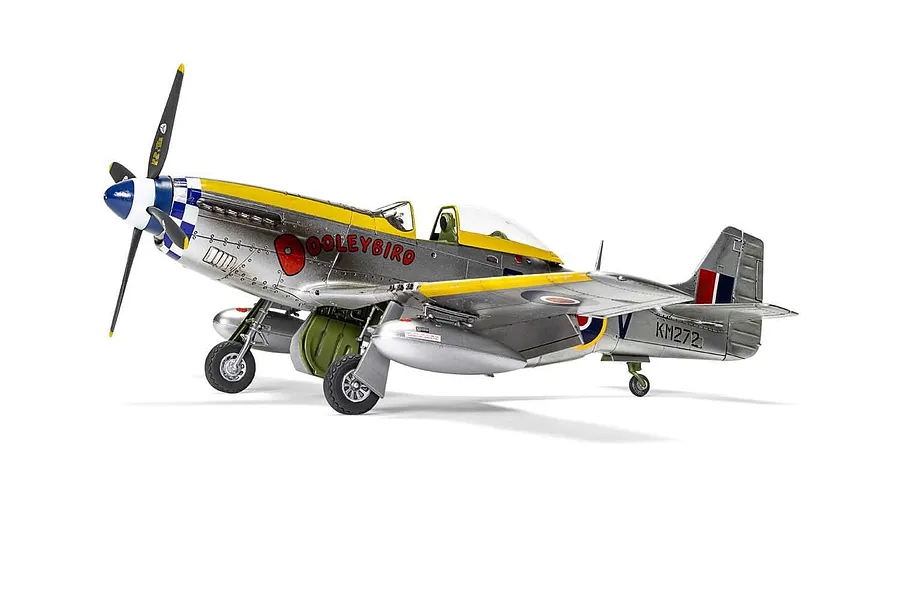 A fully assembled and painted 1/48 scale plastic model of a North American Mustang Mk.IV fighter plane, featuring a silver finish with yellow and blue markings.