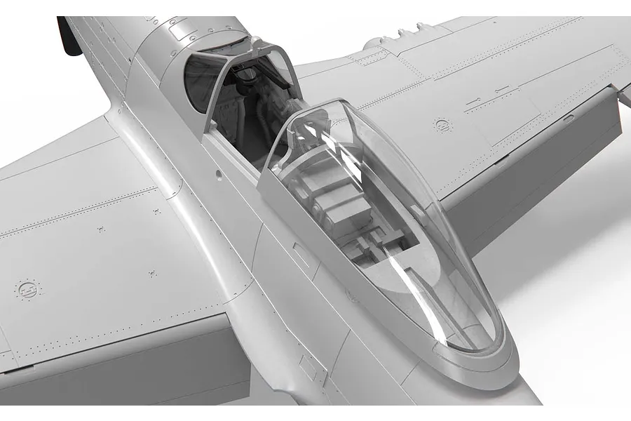 Close-up of the cockpit area of an unpainted grey plastic model P-51 Mustang aircraft kit.