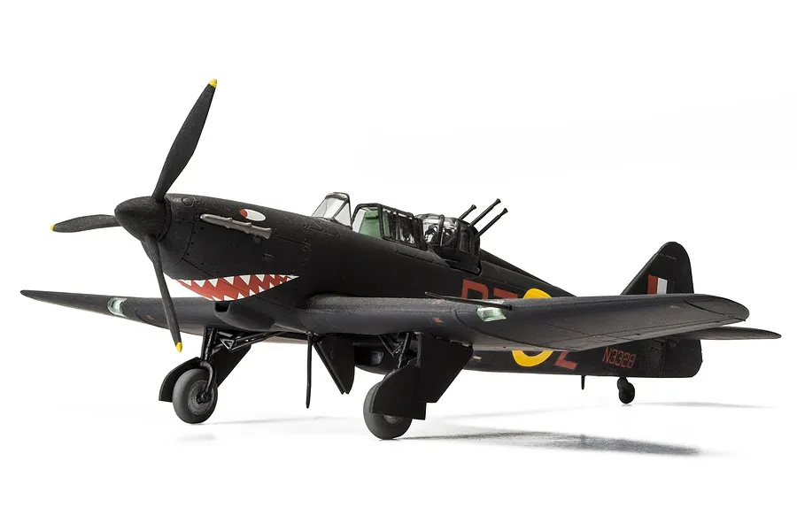 A 1/72 scale plastic model of a Boulton Paul Defiant fighter aircraft, painted in black with shark mouth nose art, standing on a white background.