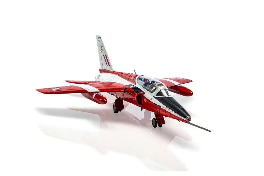 A fully assembled and painted 1/72 scale plastic model of a Folland Gnat T.1 jet trainer in red and white livery, shown on a white background.