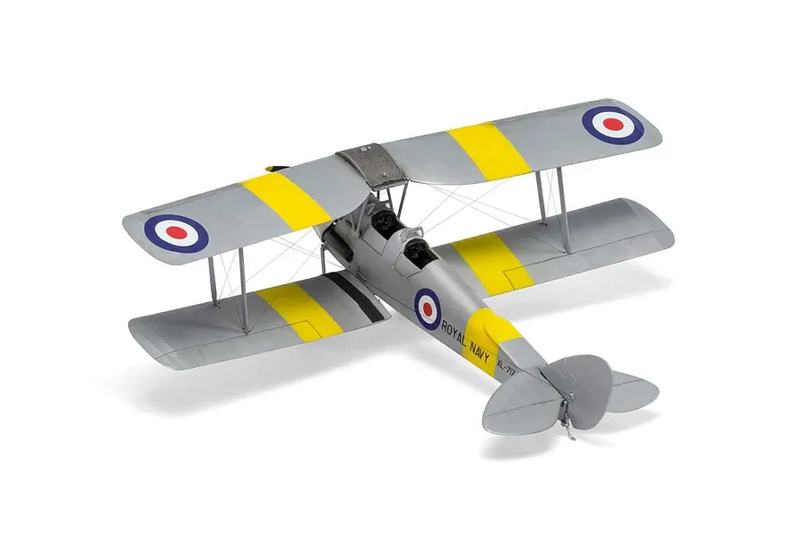 A completed 1/72 scale plastic model of a De Havilland Tiger Moth biplane, painted silver with yellow training bands and Royal Navy markings.