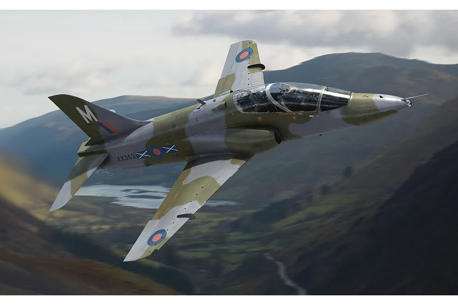 An artistic illustration of a BAE Hawk T.Mk.1A jet trainer flying over a mountainous landscape.
