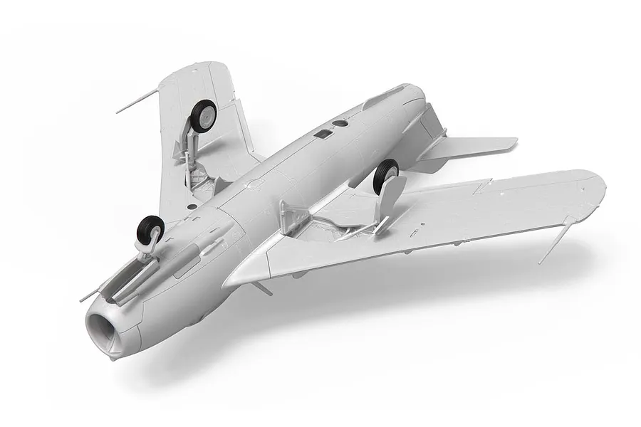 A partially assembled, unpainted grey plastic model of a Supermarine Swift fighter jet, shown from an elevated angle against a white background.