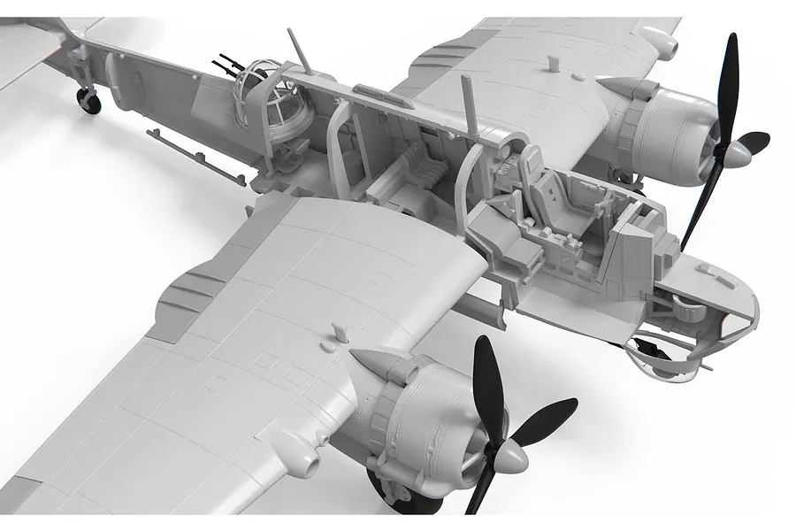 Close-up of an unpainted plastic model aircraft interior showing cockpit and fuselage details of a Bristol Beaufort bomber.