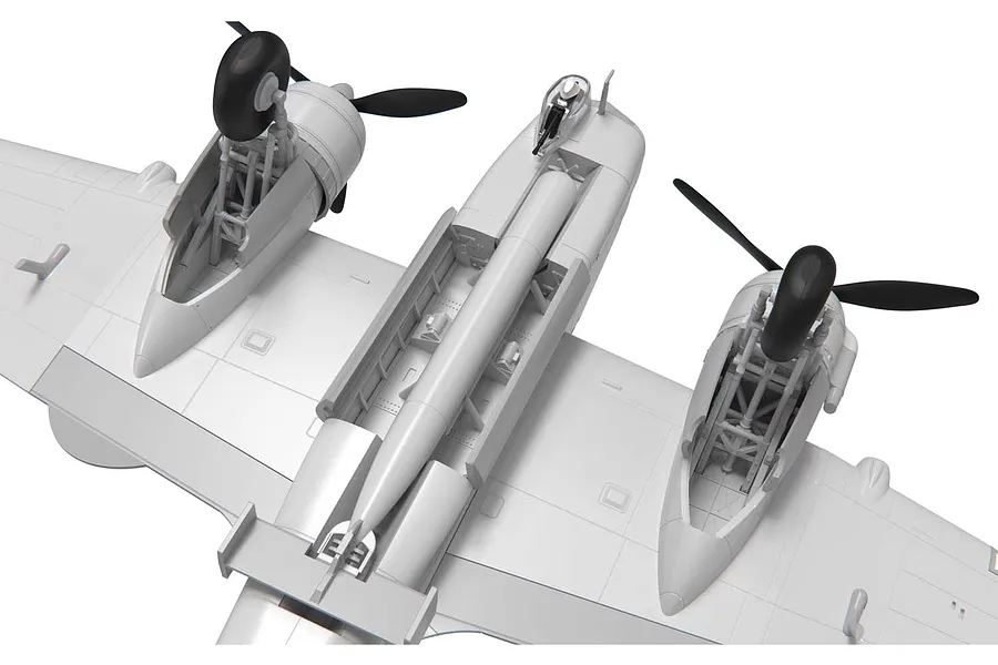 Underside view of an unpainted plastic model aircraft showing the open bomb bay with a torpedo and landing gear bays.