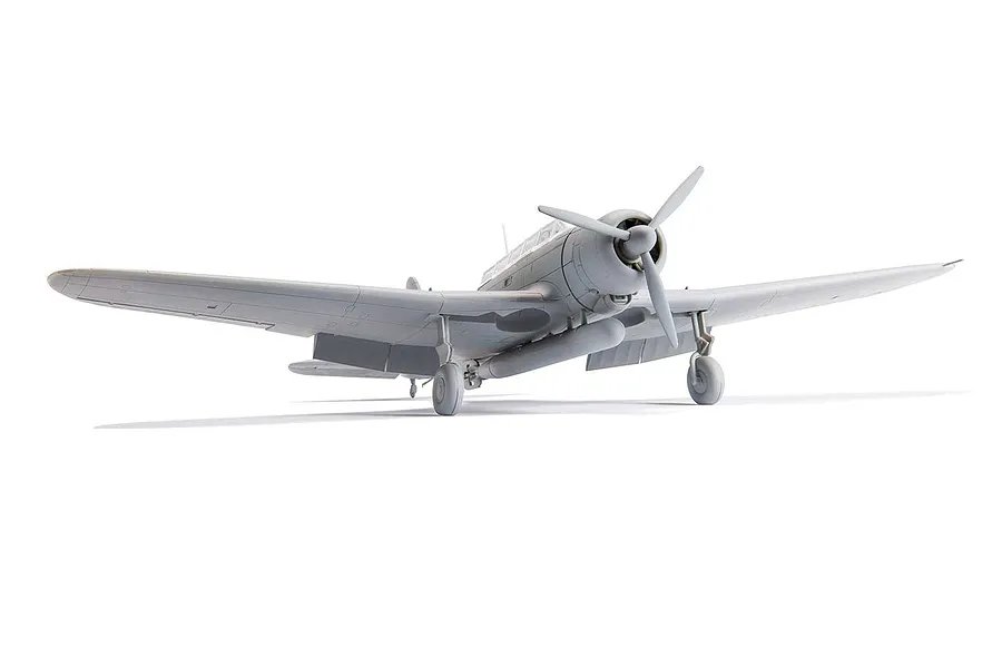 A front-quarter view of an unpainted, grey plastic model of a Nakajima B5N2 Kate bomber aircraft on a white background.