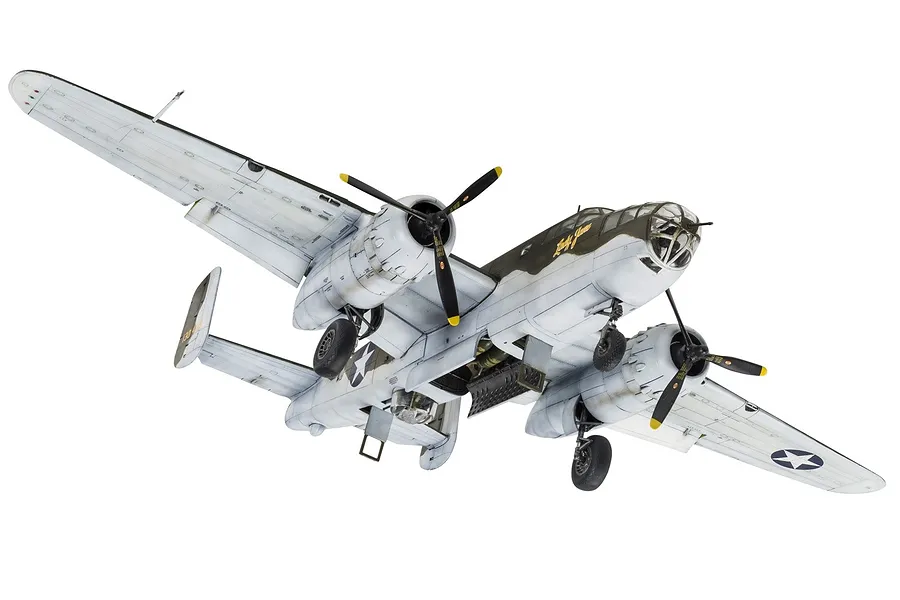 A completed 1/72 scale plastic model of a North American B-25 Mitchell bomber, painted in a camouflage scheme with landing gear deployed.