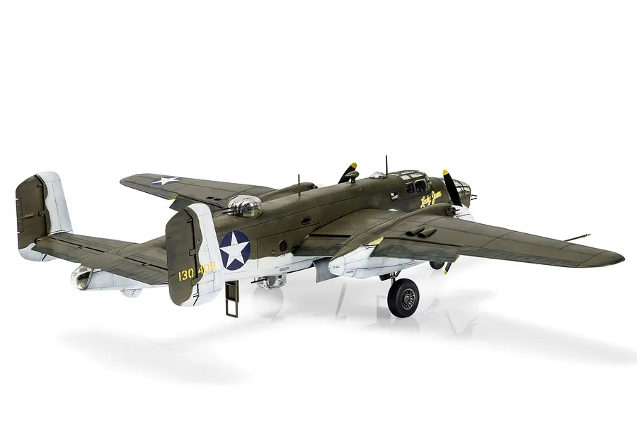 A completed 1/72 scale plastic model of a North American B-25 Mitchell bomber, painted in olive drab and grey camouflage with Lady Jane nose art.