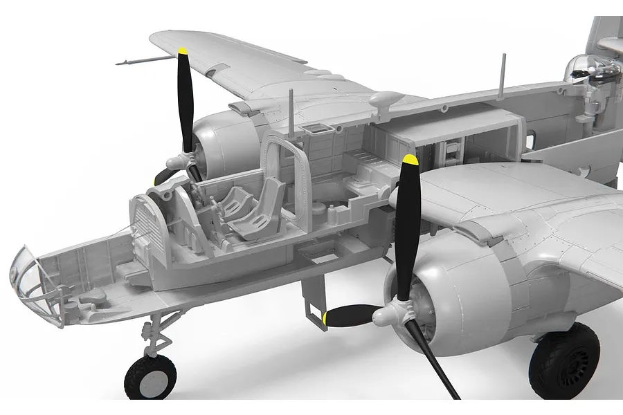 A close-up view of a partially assembled plastic model aircraft showing the detailed interior cockpit and fuselage structure.