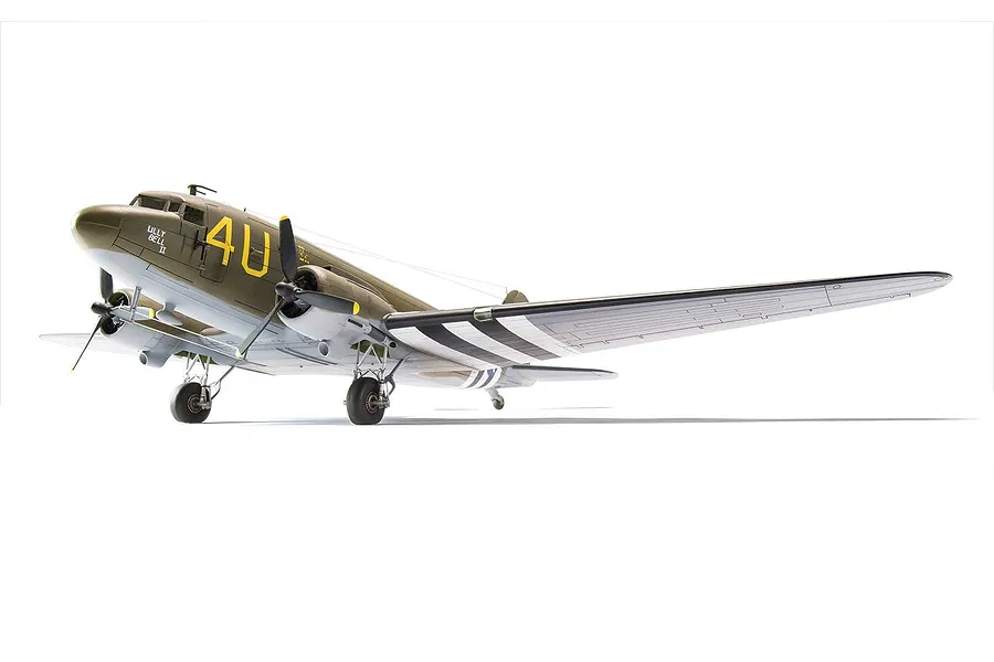 A completed 1/72 scale plastic model of a Douglas C-47 Skytrain military transport aircraft, painted in olive drab and grey with invasion stripes.
