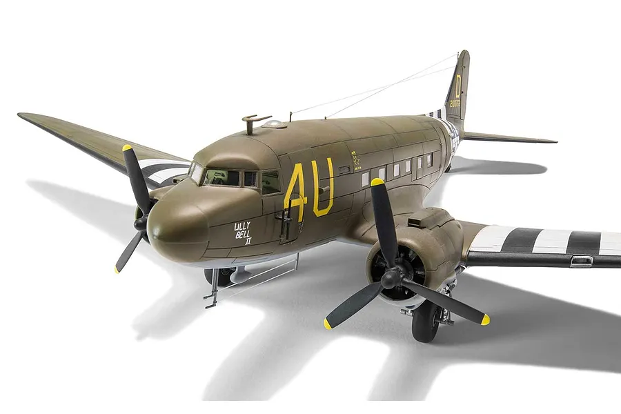 A fully assembled and painted 1/72 scale plastic model of a Douglas C-47 Skytrain military transport aircraft, featuring olive drab camouflage and invasion stripes.