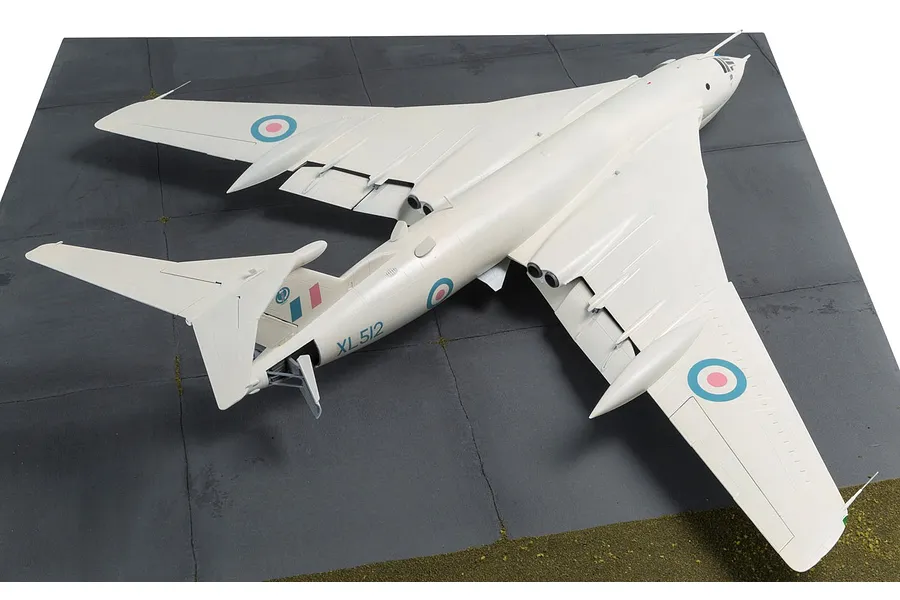 A high-angle view of a completed 1/72 scale Handley Page Victor B.2 plastic model aircraft, painted in white with RAF markings, displayed on a diorama base.