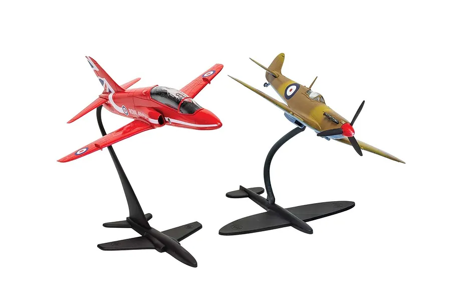Two assembled Airfix model aircraft on display stands: a red RAF Hawk jet and a camouflaged Spitfire fighter plane.