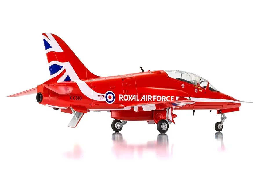 A side-view of a 1/72 scale plastic model of a Red Arrows Hawk trainer jet, painted in iconic red with Union Jack tail markings.