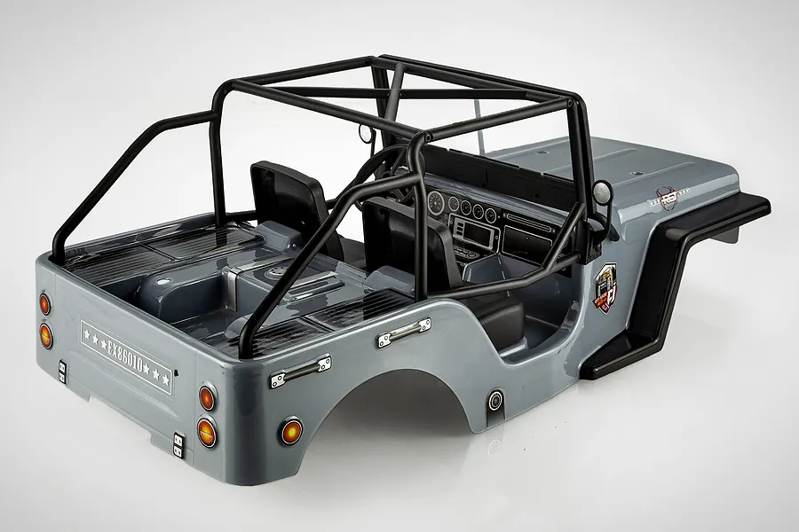 Grey painted RC Jeep body shell with a black roll cage, interior seats, and dashboard, viewed from a high rear angle against a white background.