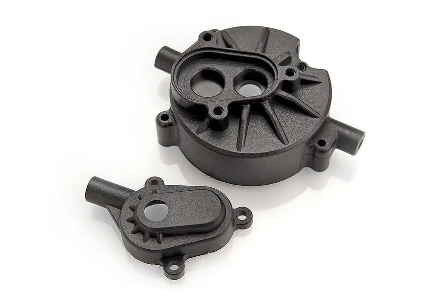 Two black plastic RC transmission gear housing components shown from a top-down perspective on a white background.