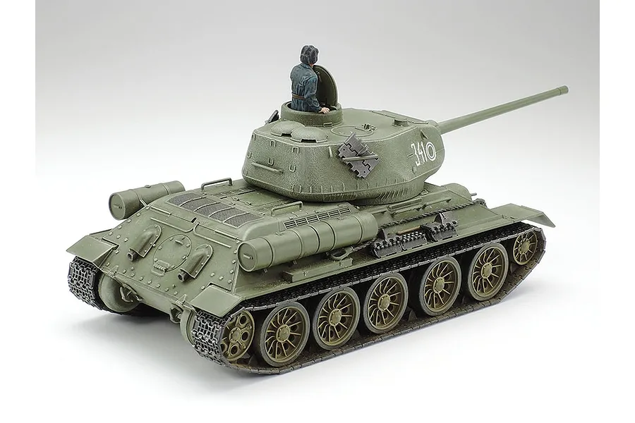 A Tamiya 1/48 scale T-34/85 Russian medium tank plastic model kit, painted in olive green with a tank commander figure in the hatch.
