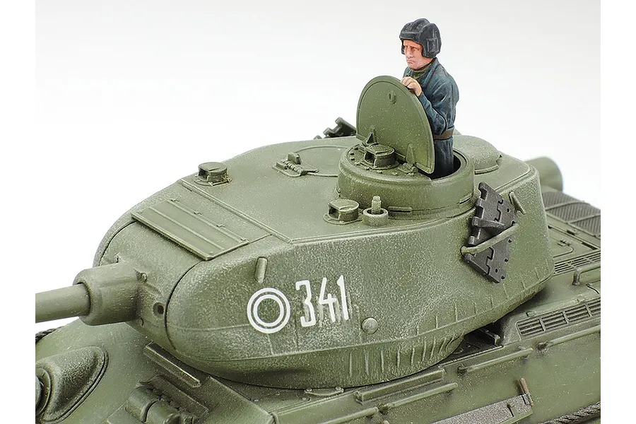 Close-up of a Tamiya 1/48 scale T34/85 tank model showing the turret, hatch, and a painted tank commander figure.