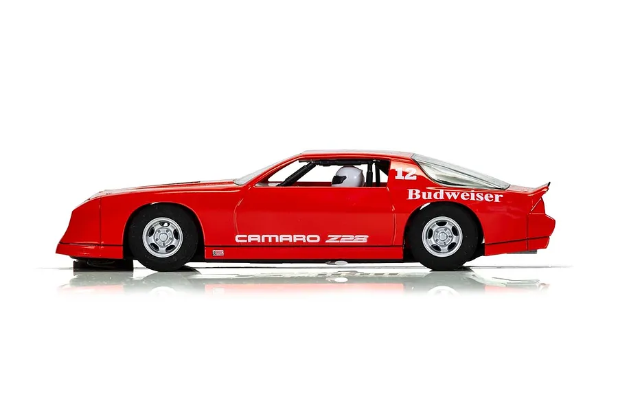 Side profile of a red Scalextric 1/32 scale Chevrolet Camaro IROC-Z slot car with number 12 and Budweiser branding.