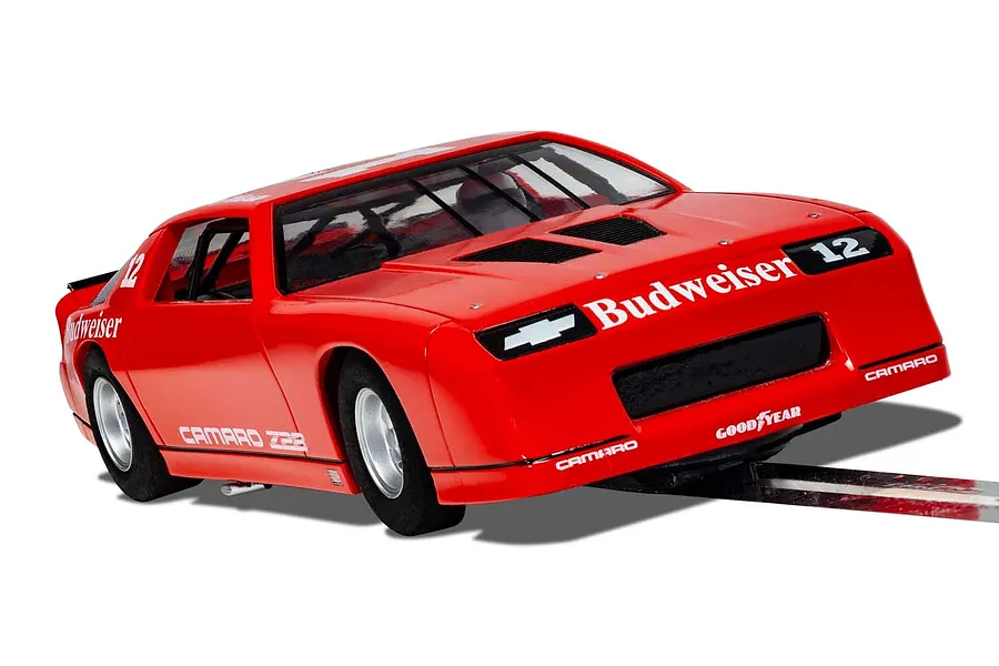 A red Scalextric 1/32 scale Chevrolet Camaro IROC-Z slot car featuring Budweiser branding and racing number 12, shown on a track section.