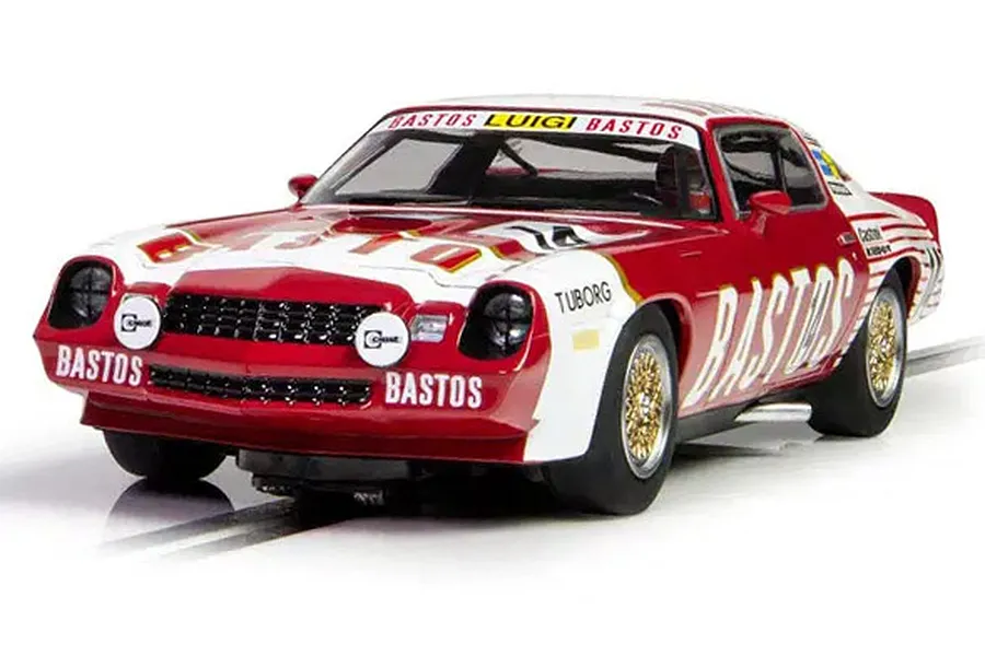 A 1/32 scale Scalextric Chevrolet Camaro Z28 slot car in red and white Bastos livery on a track.