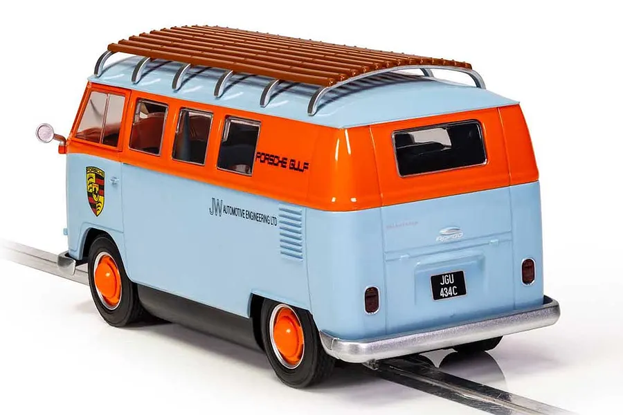 Rear three-quarter view of a Scalextric 1/32 scale VW T1B Microbus slot car in Gulf blue and orange livery with a roof rack on a track section.