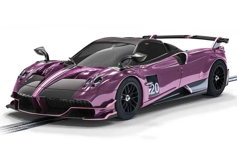 A 1/32 scale Scalextric Pagani Huayra Roadster BC slot car in metallic purple with black accents, displayed on a slot car track.