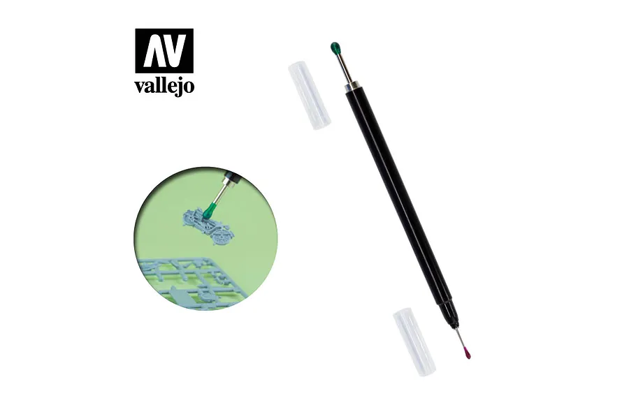 Vallejo double-ended pick and place tool with a green wax tip and a fine metal point, shown with protective caps and an inset demonstrating its use on a model part.