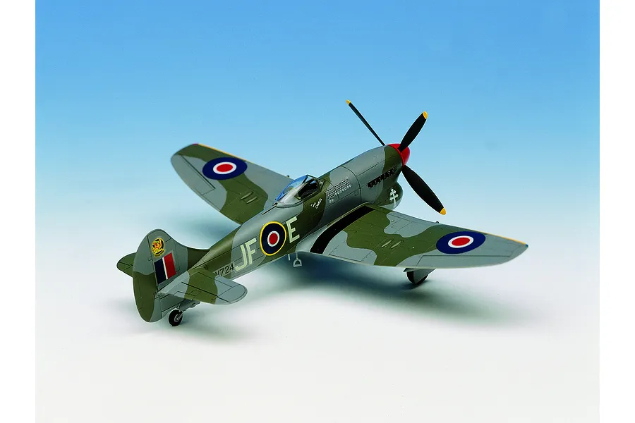A 1/72 scale plastic model kit of a Hawker Tempest V fighter plane, painted in RAF camouflage with JF-E markings, displayed against a blue gradient background.