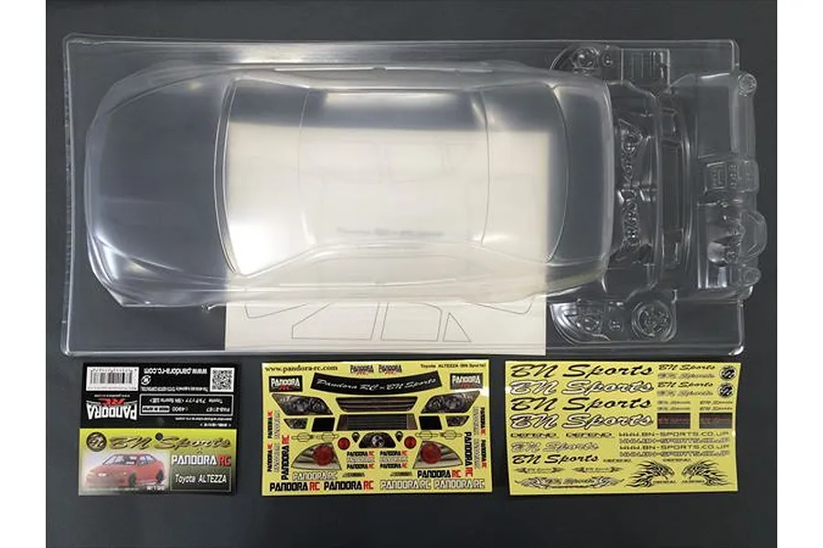 Unpainted clear polycarbonate RC car body shell for a Toyota Altezza BN Sports, including decal sheets and packaging header card.