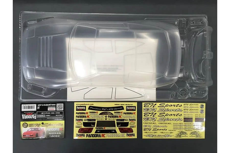 An unpainted clear polycarbonate 1/10 scale Nissan 180SX RC car body shell by Pandora RC, including decal sheets and window masks in clear plastic packaging.