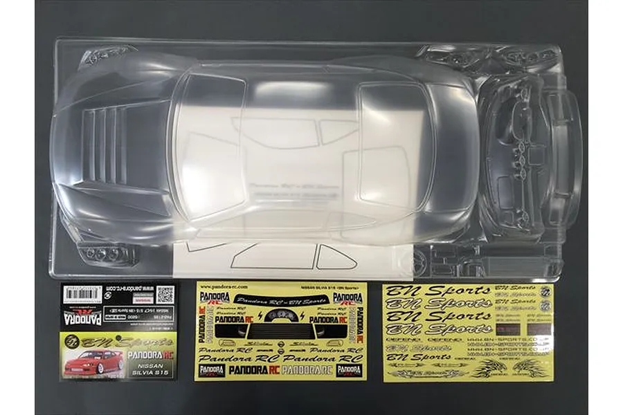 An unpainted clear polycarbonate RC car body shell for a Nissan Silvia S15 by Pandora RC, including decal sheets and window masks in original packaging.
