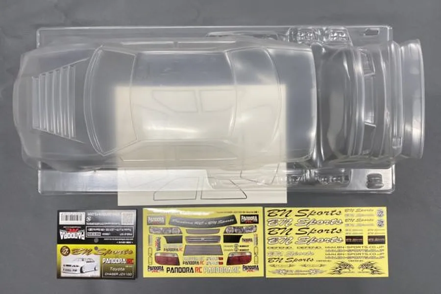 An unpainted clear polycarbonate RC car body shell for a Toyota Chaser JZX100 by Pandora RC, including decal sheets and window masks.