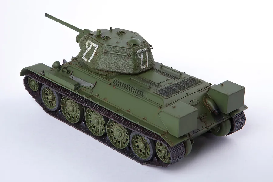 A 1/35 scale model of a Soviet T-34/76 tank, painted olive green with white '27' markings on the turret, viewed from a high rear angle.