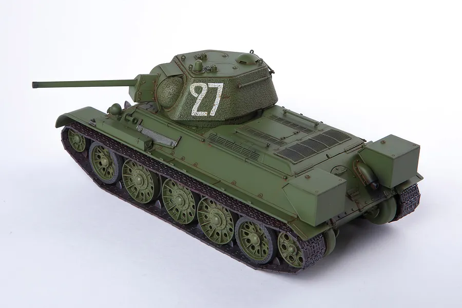 A 1/35 scale model of a Soviet T-34/76 tank painted in olive green with the number 27 on the turret, shown from a high-angle rear perspective.