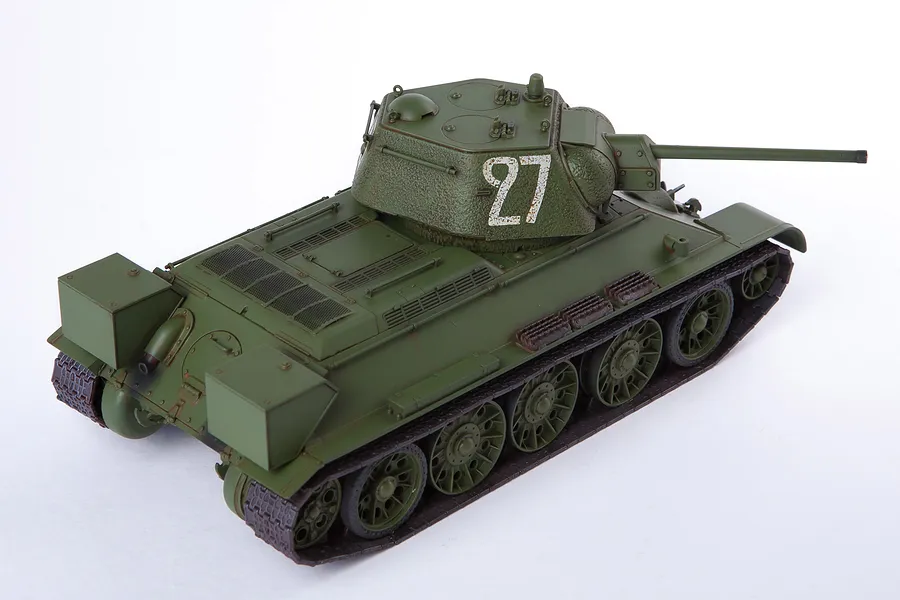 A fully assembled and painted 1/35 scale model of a Soviet T-34/76 tank, featuring a green paint scheme and the number 27 on the turret.