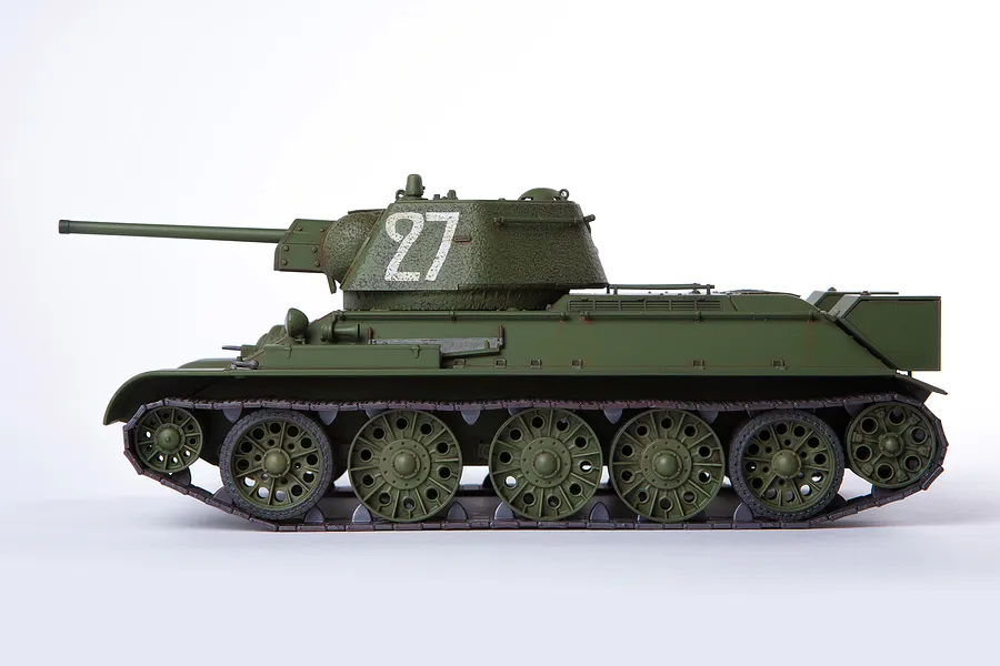 Side view of an assembled and painted 1/35 scale Academy USSR T-34/76 tank model with the number 27 painted on the turret.
