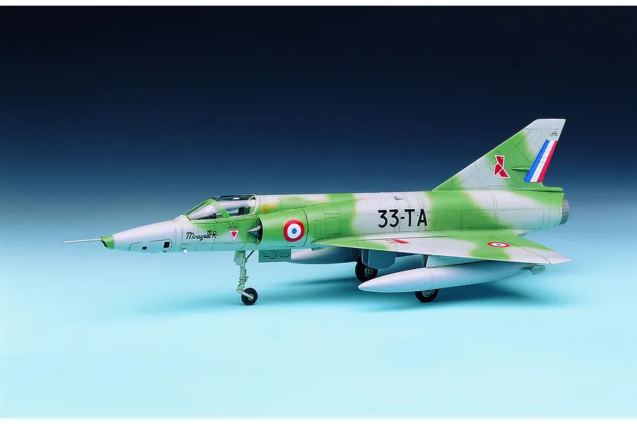 A side-profile view of a completed 1/48 scale plastic model kit of a French Mirage III R fighter jet with green and grey camouflage.
