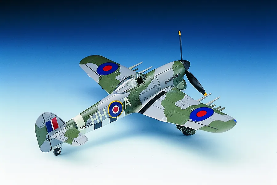 A completed 1/72 scale plastic model of a Hawker Typhoon Mk.IB fighter plane with green and grey camouflage and RAF markings.