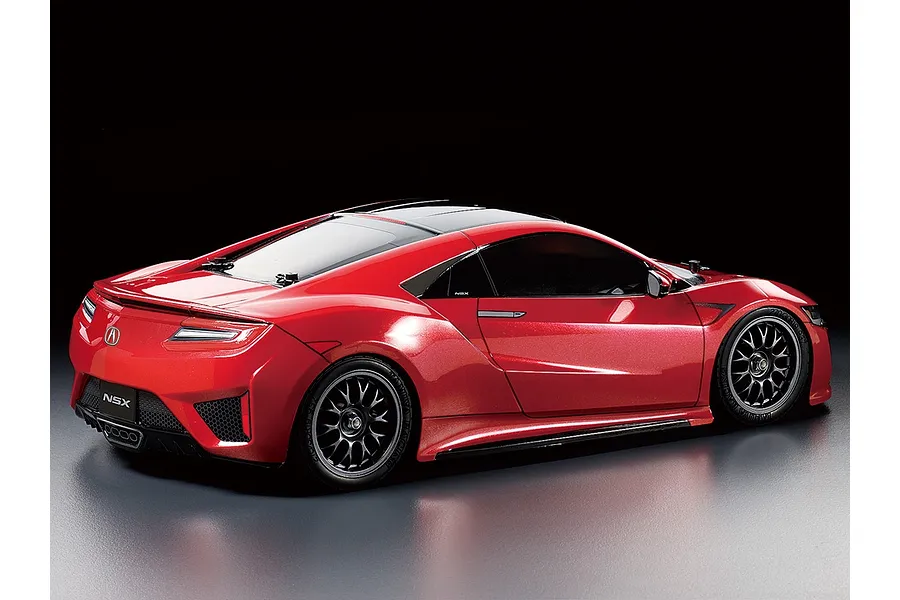 A rear three-quarter studio shot of a red Tamiya NSX RC car model on a dark background.