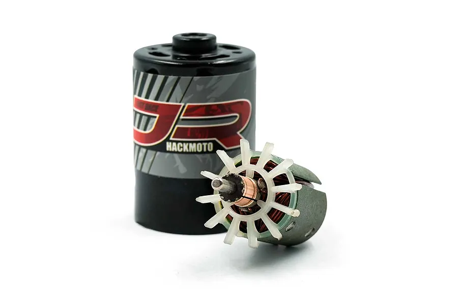 Yeah Racing Hackmoto Just-Race 540 brushed motor with its rotor removed and placed in front of the motor can.