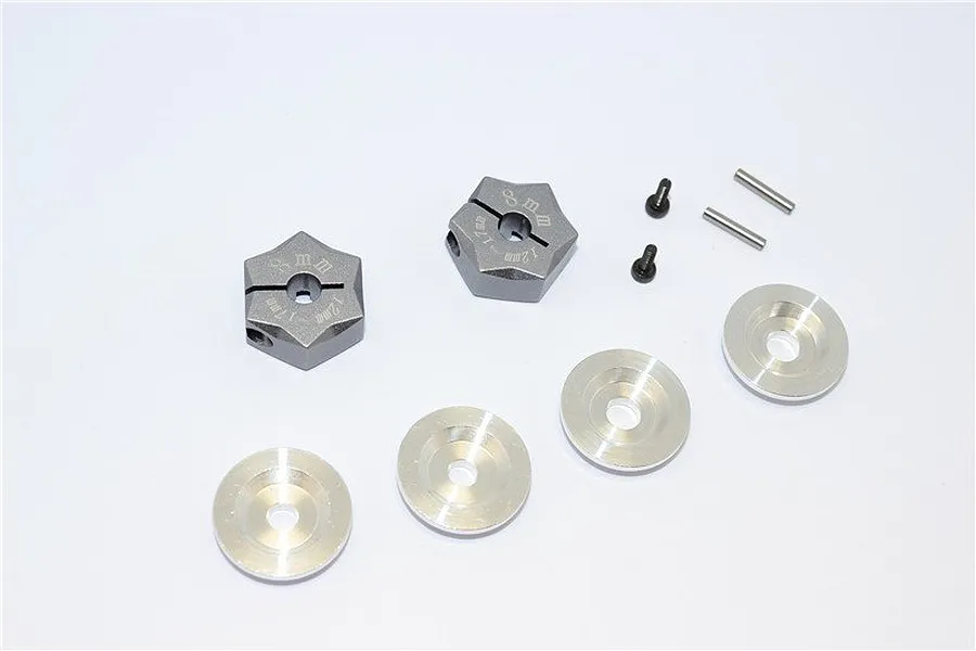 GPM Racing 12mm to 17mm hex adapter set including two grey aluminium hexes, four silver washers, two small screws, and two metal pins.
