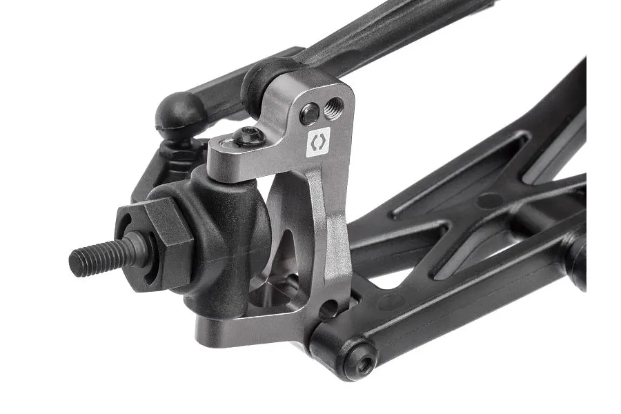 Close-up of a grey aluminium C-hub carrier installed on an RC car suspension arm with black plastic components.