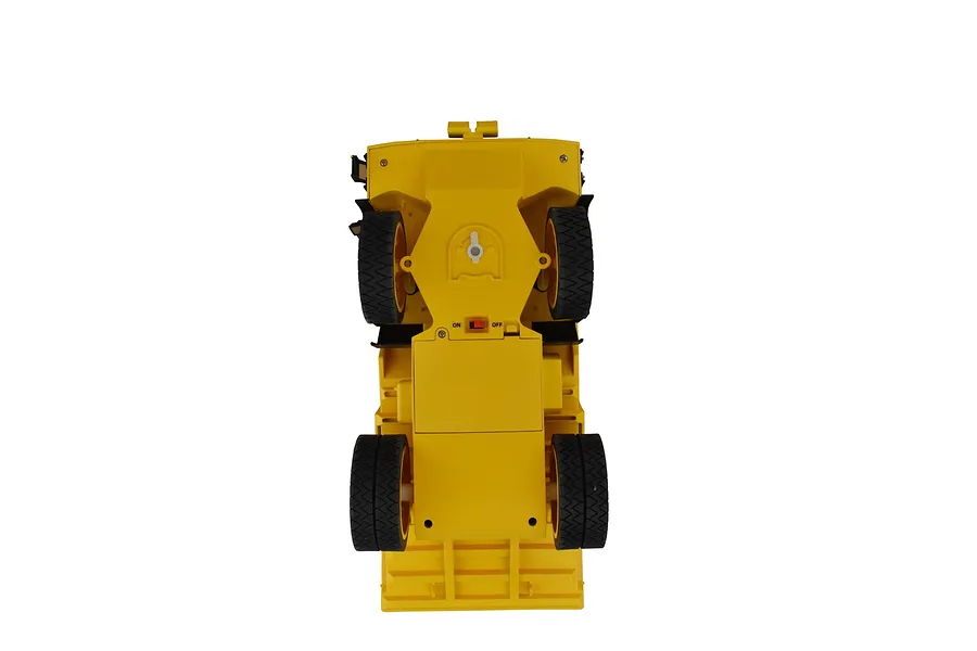 Underside view of the Diecast Masters CAT 770 RC mining truck showing the battery compartment, steering trim dial, and power switch.