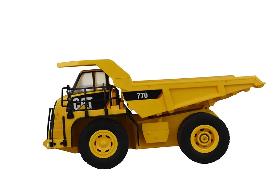 Side view of a yellow Diecast Masters CAT 770 RC mining truck model on a white background.