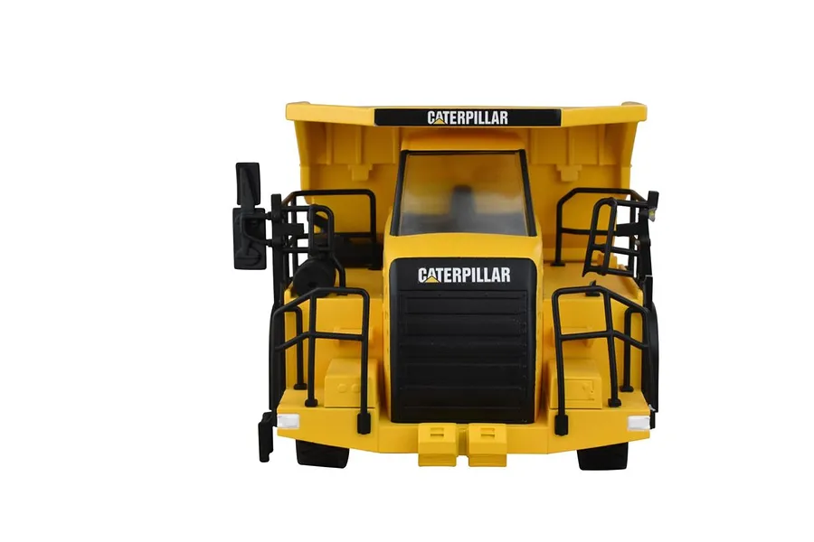 Front view of a Diecast Masters CAT 770 RC mining truck in yellow and black, showcasing the cab, grille, and safety railings.